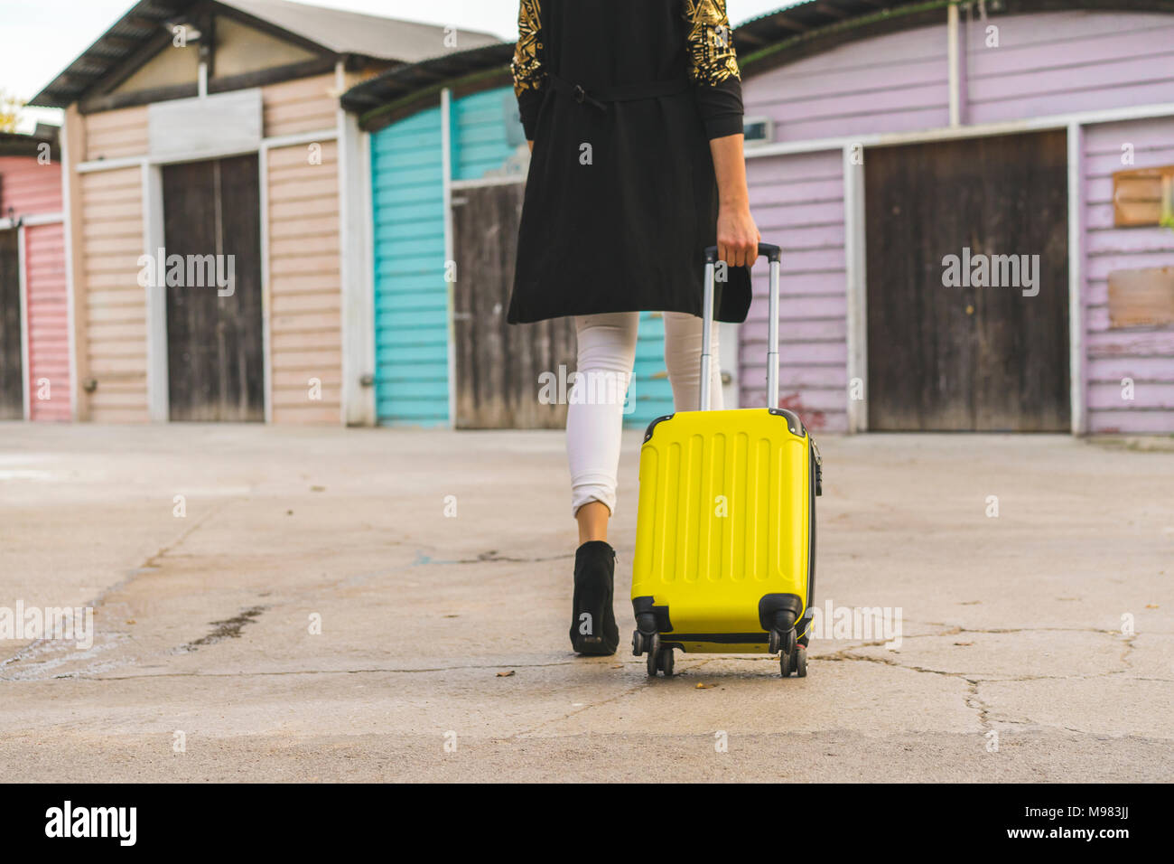 Download Back View Of Walking Woman With Yellow Trolley Bag Partial View Stock Photo Alamy PSD Mockup Templates