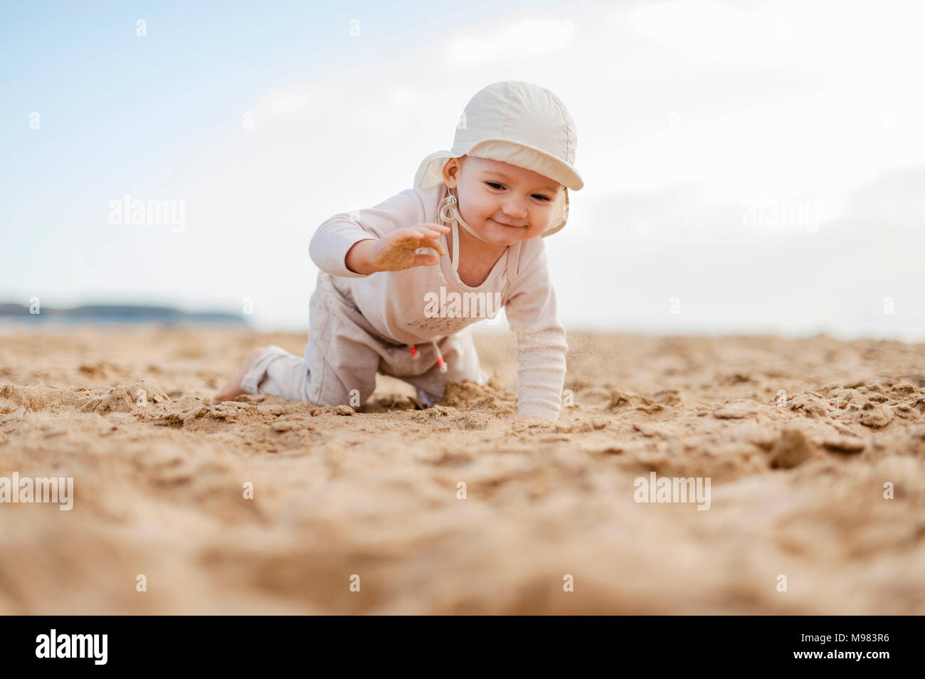 Spain, Lanzarote, baby girl crawling on the beach Stock Photo