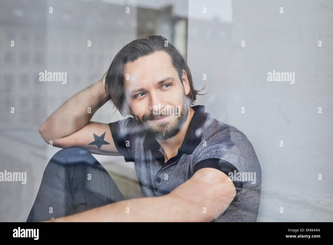 Man sitting hand behind hi-res stock photography and images - Alamy
