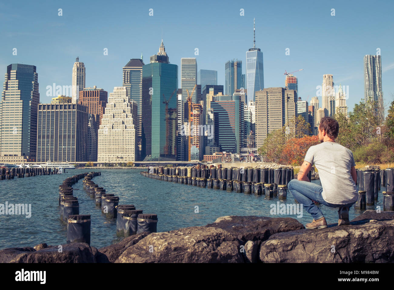 USA, New York City, man looking at skyline with One World Trade Center