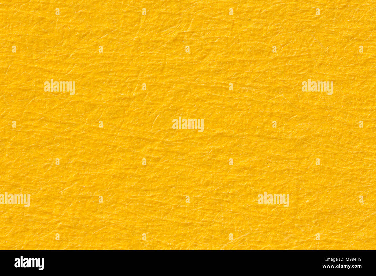Yellow paper texture useful as a background. Stock Photo