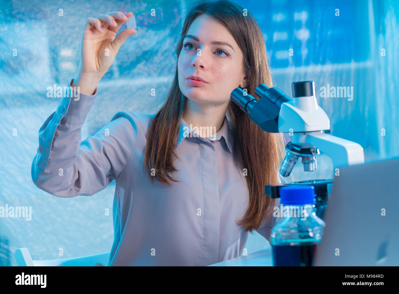 female technician take sample on microscope slide Stock Photo - Alamy