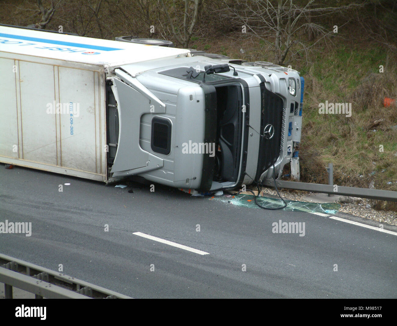 Lorry crash on motorway, lorry on its side, road traffic collision (RTC) Stock Photo