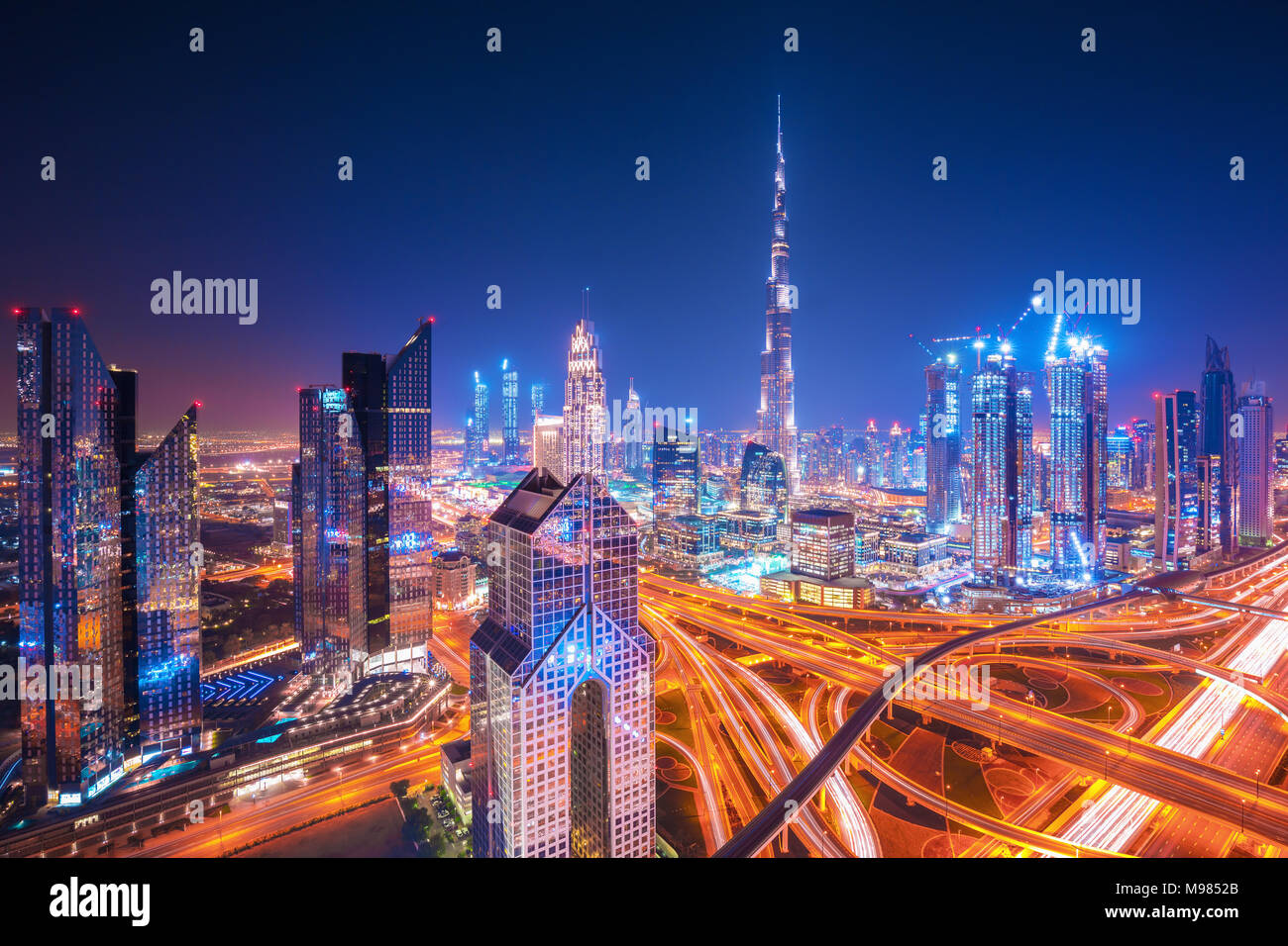 Dubai skyline at sunset with beautiful city center lights and Sheikh Zayed road traffic, Dubai, United Arab Emirates Stock Photo