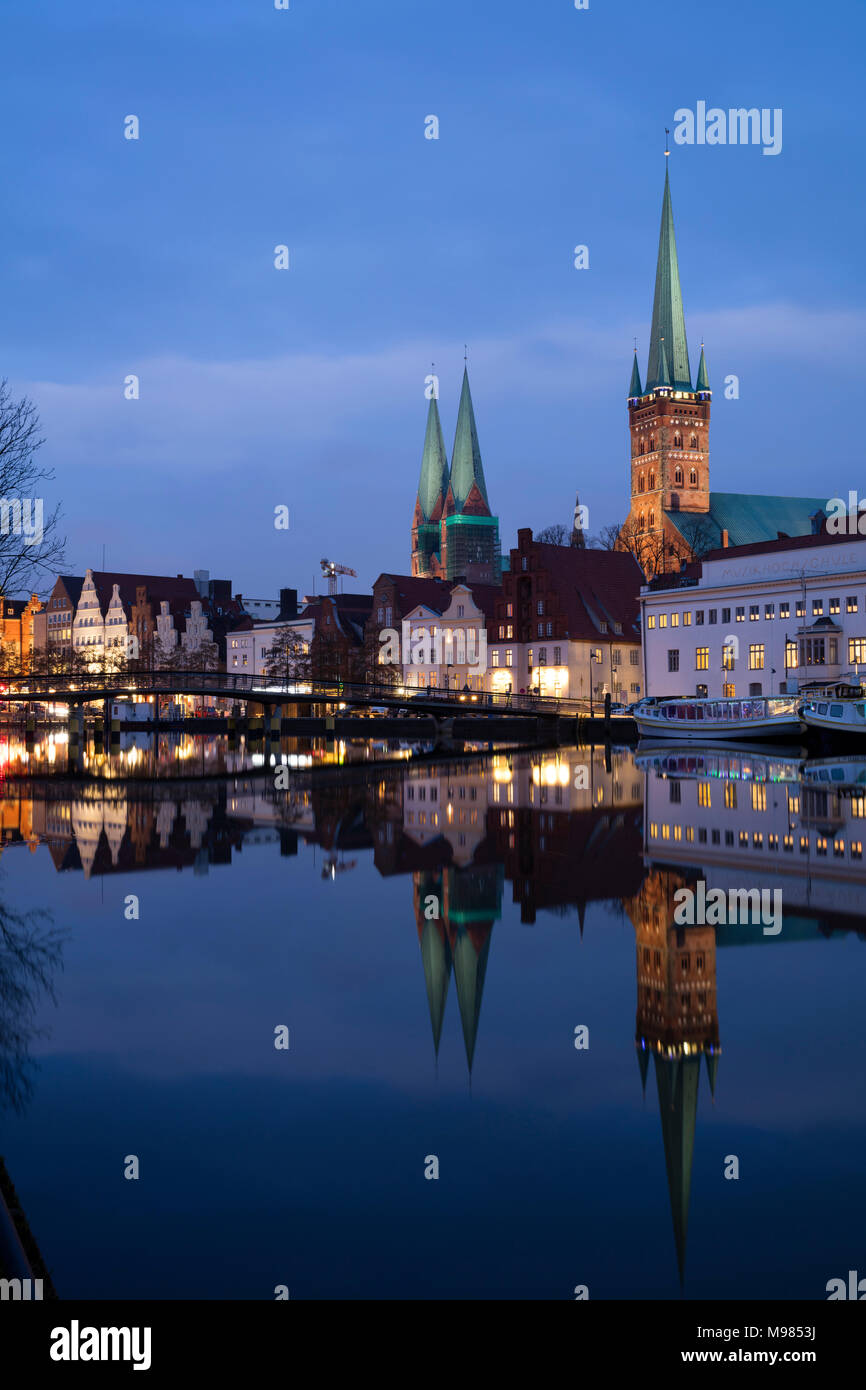 Germany, Schleswig-Holstein, Luebeck, Old town, Obertrave river, St Mary's Church and St. Petri church at blue hour Stock Photo