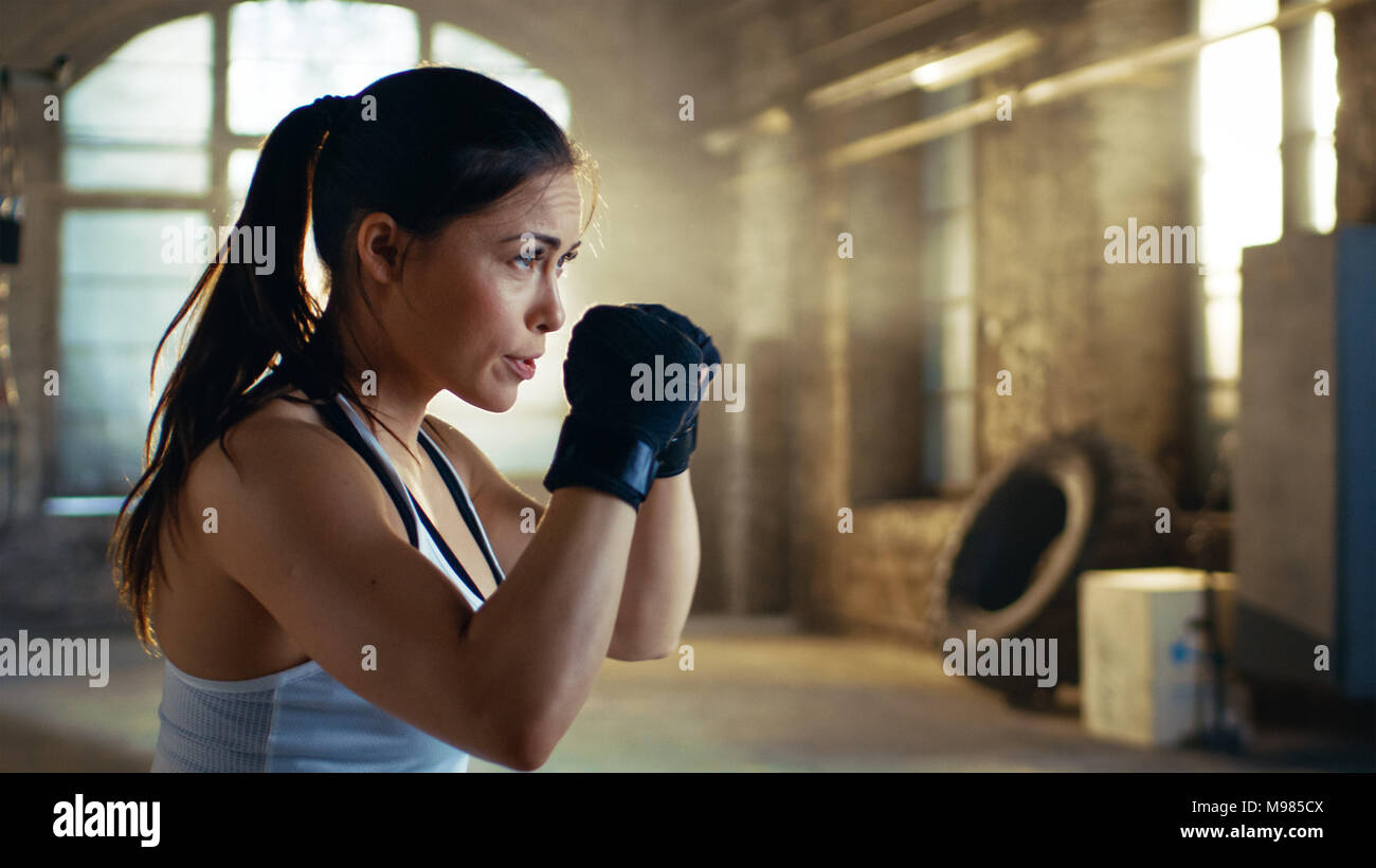 Beautiful Athletic Woman holds her Arms Ready for Defending Herself. It is a Part of Her Intensive Cross Fitness Gym Training. Stock Photo