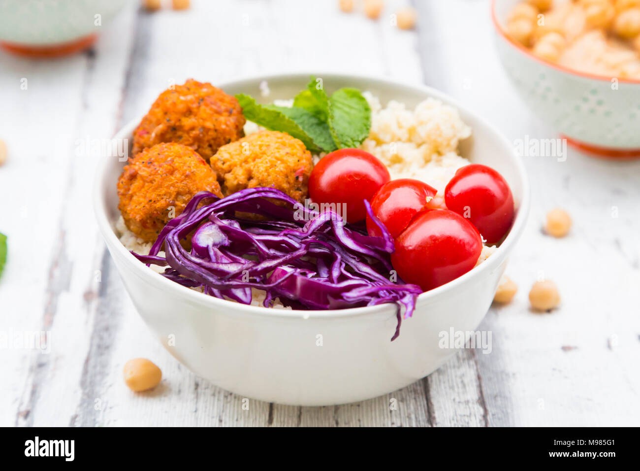 Buddha bowl of sweet potato balls, Couscous, Hummus and vegetables