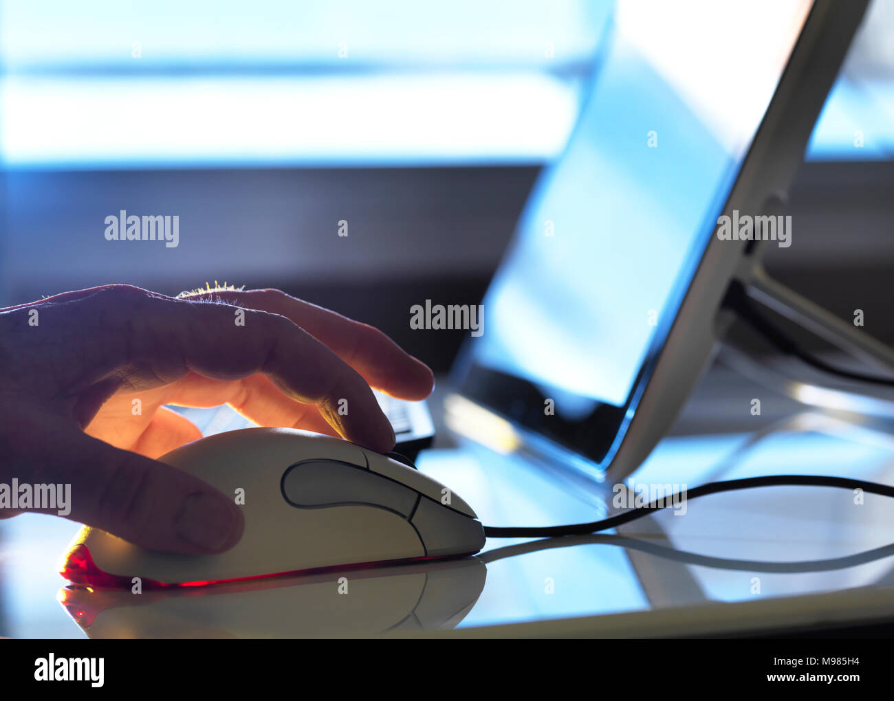 Detail of man working at computer Stock Photo