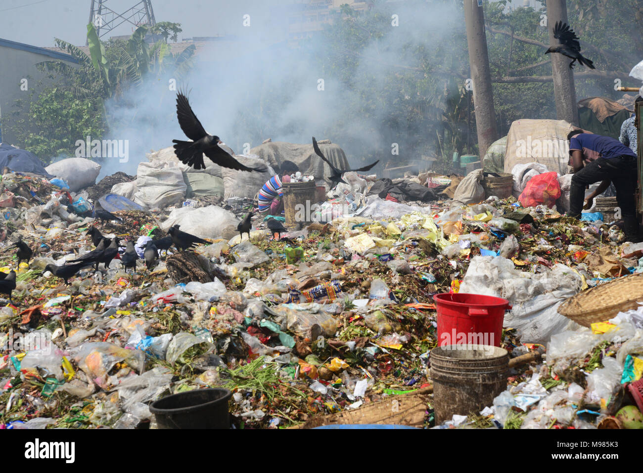 Bangladeshi people waste picker picks the non- biodegradable waste to be used for the recycling industry in waste Dump Yard in Dhaka. Bangladesh. On M Stock Photo