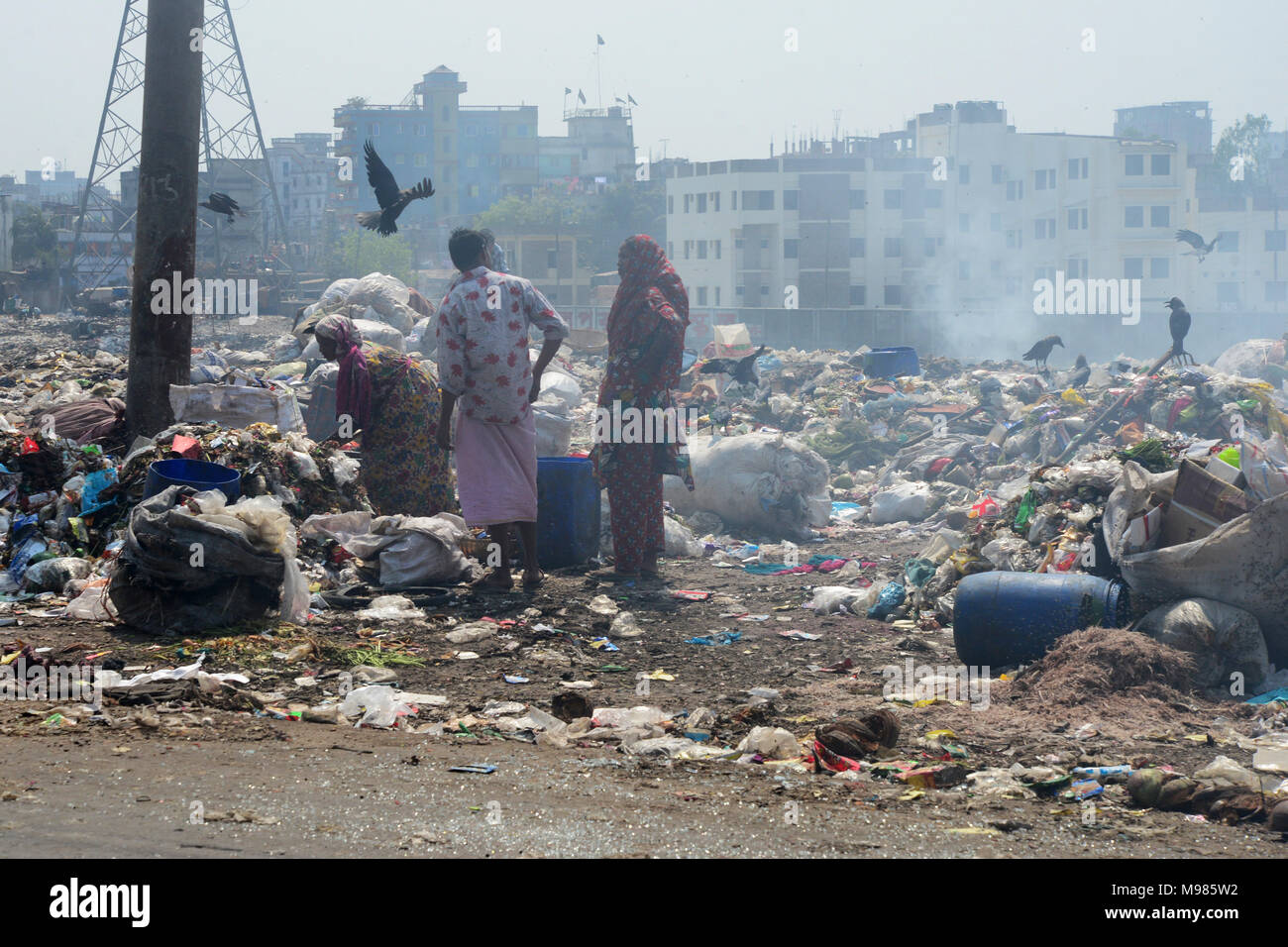 Bangladeshi people waste picker picks the non- biodegradable waste to be used for the recycling industry in waste Dump Yard in Dhaka. Bangladesh. On M Stock Photo