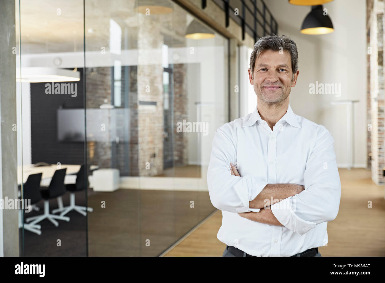 Portrait of confident businessman in modern office Stock Photo