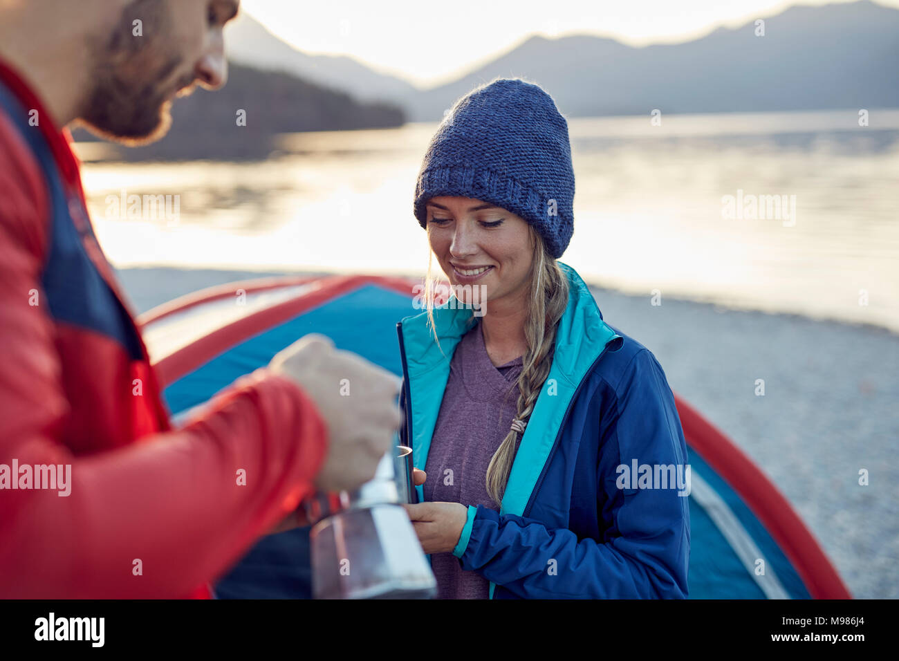 Young couple at tent having coffee break Stock Photo
