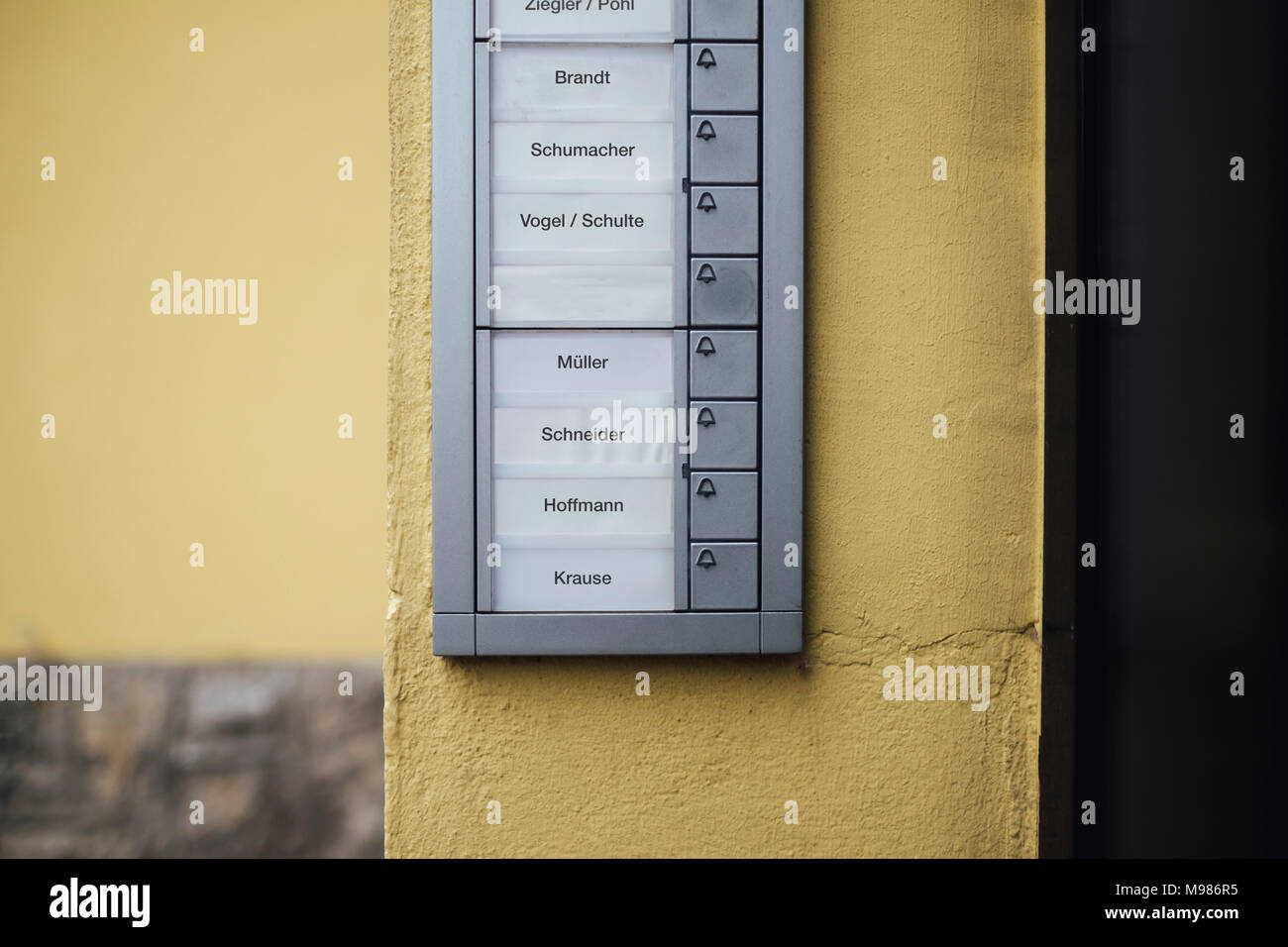 Germany, doorbell button panel with empty nameplate of deceased neighbour Stock Photo