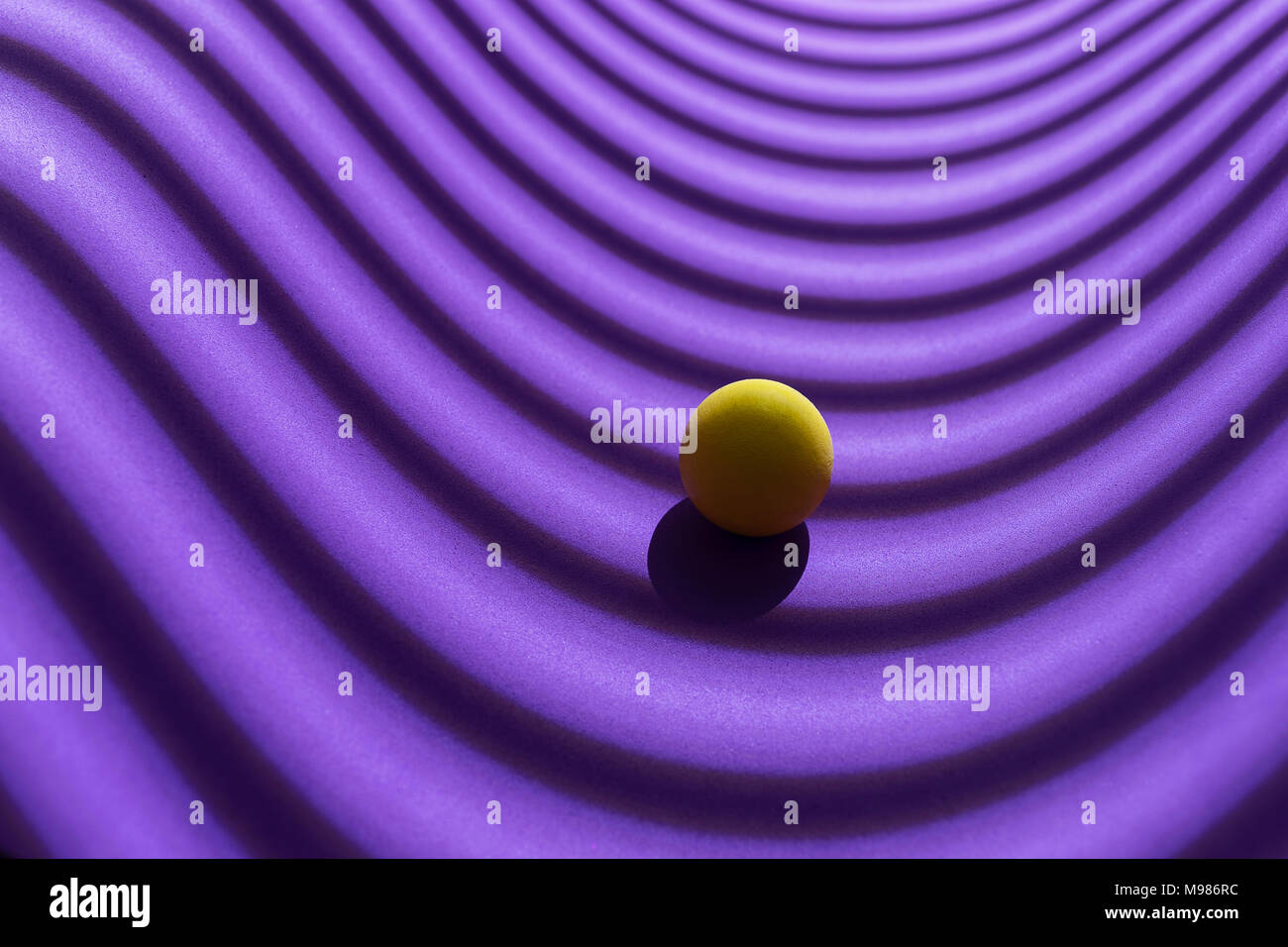 Yellow sphere over a geometric purple background, 3D Rendering Stock Photo