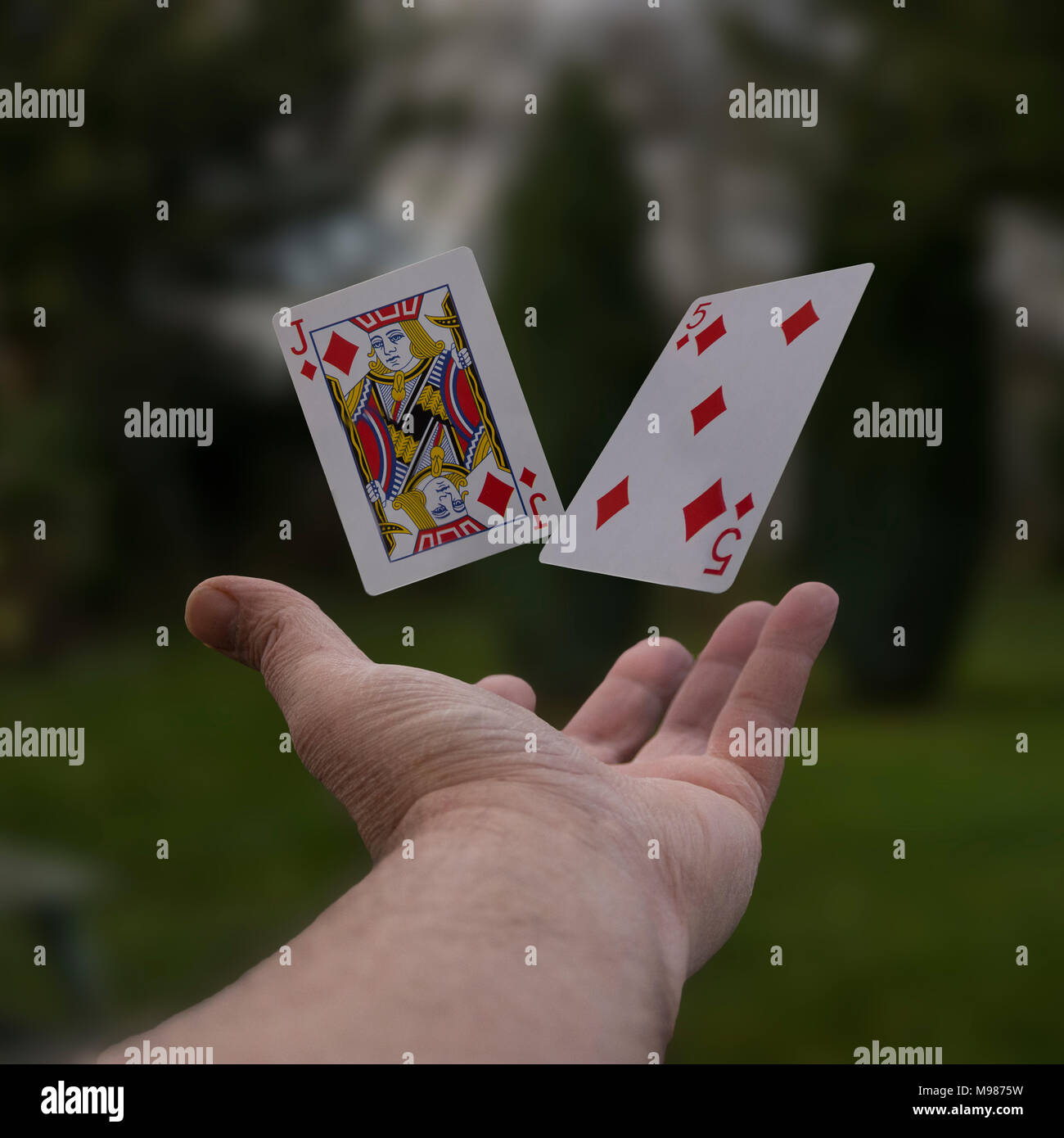 Two playing cards floating in the air Stock Photo