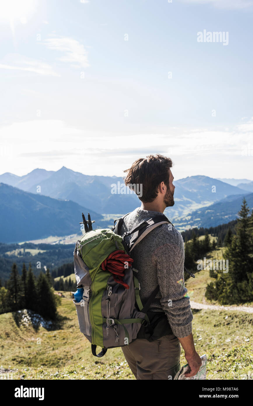 Austria, Tyrol, young man in mountainscape looking at view Stock Photo
