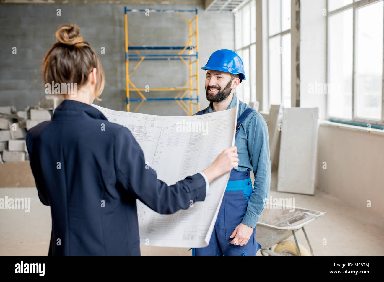 Builder with businesswoman at the construction site Stock Photo