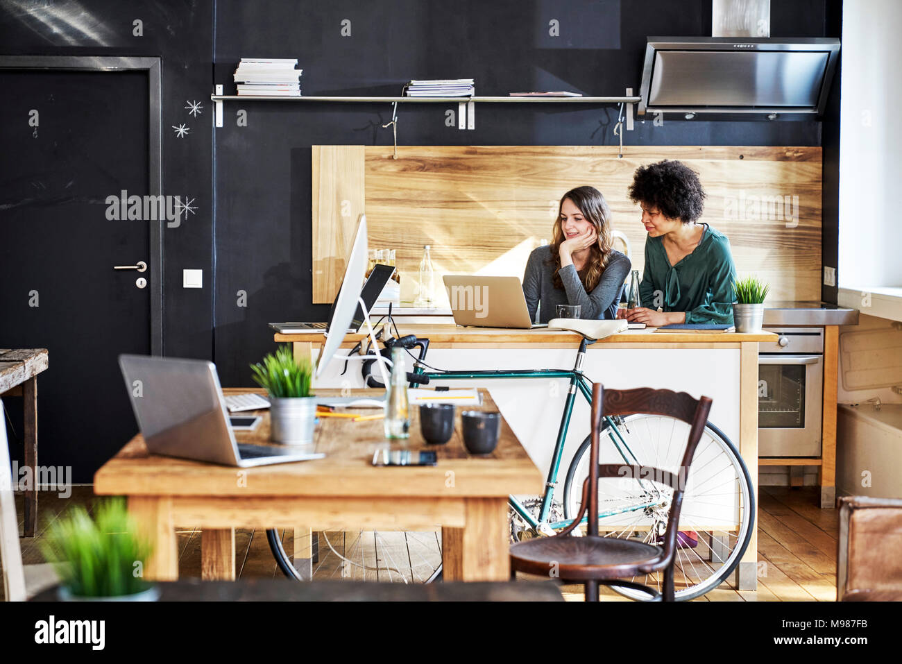 Two colleagues in office using computer hi-res stock photography and ...
