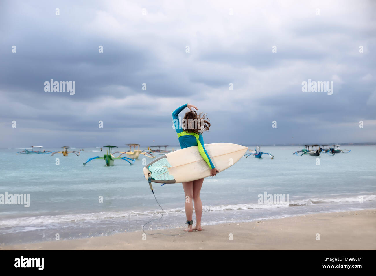 Woman holding surfing board hi-res stock photography and images - Alamy