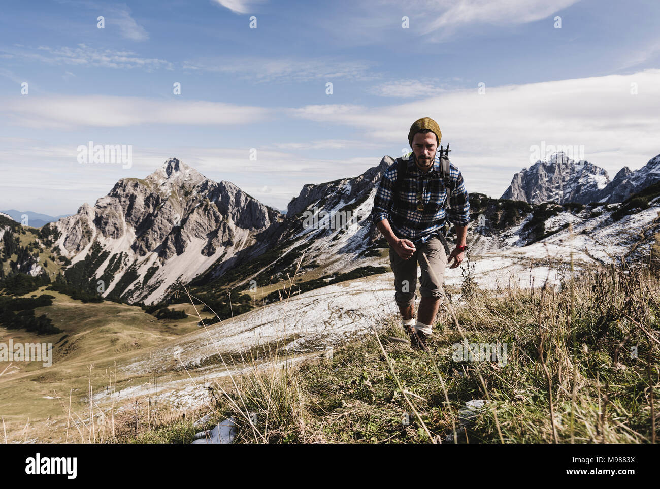 Austria, Tyrol, young man hiking in the mountains Stock Photo