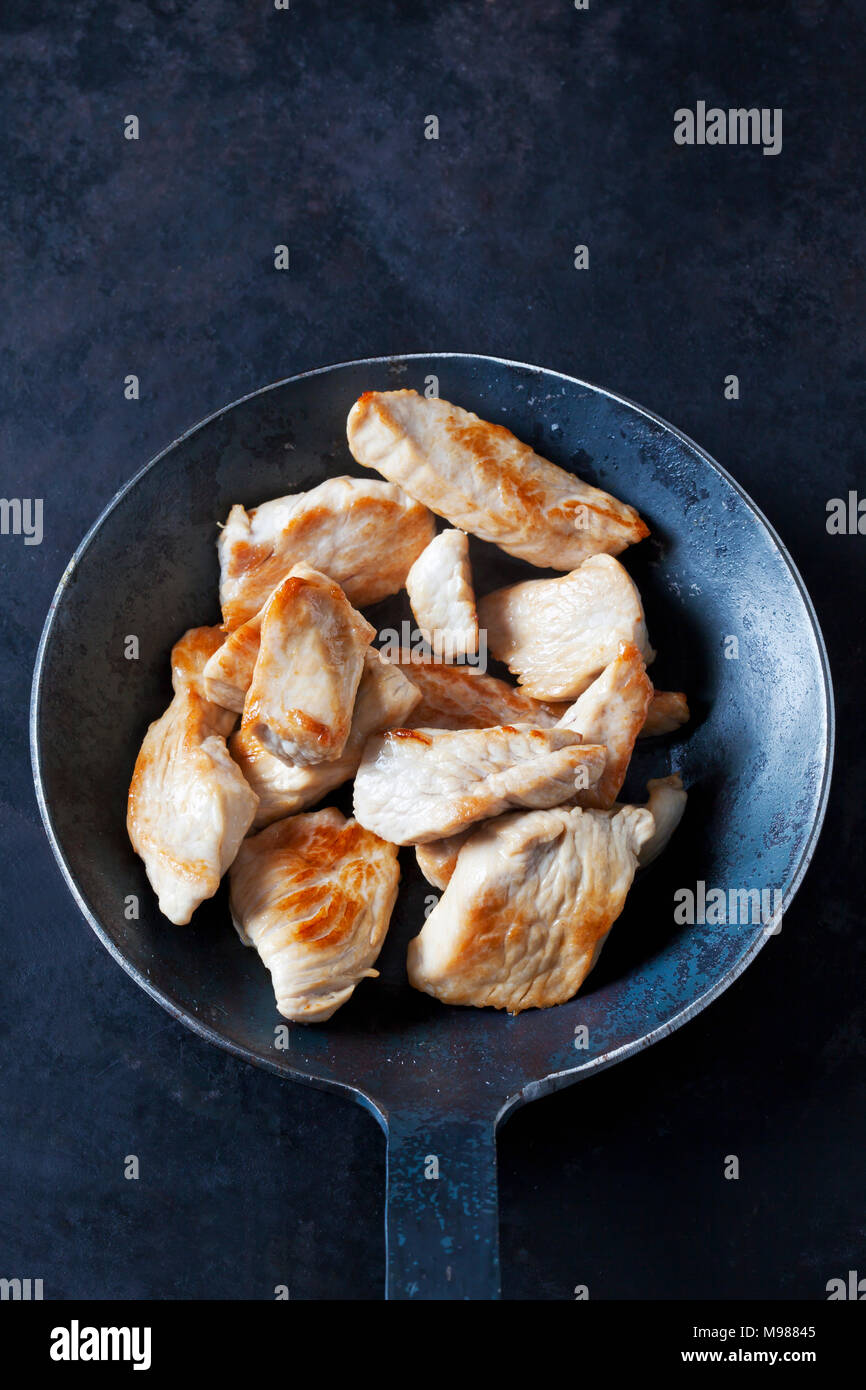 Fillet of turkey in frying pan Stock Photo
