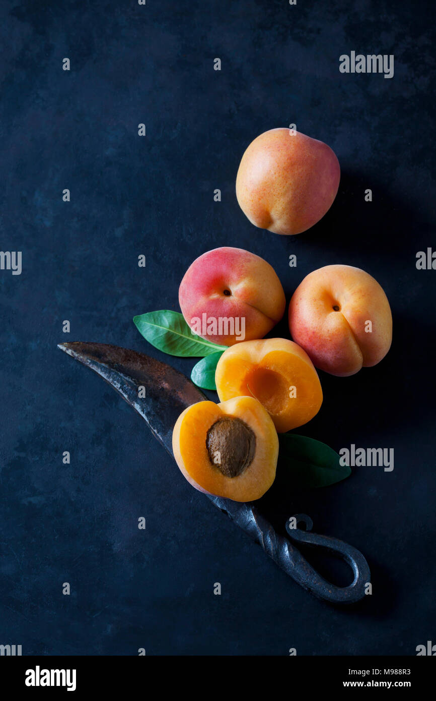 Whole and sliced apricots on dark ground Stock Photo
