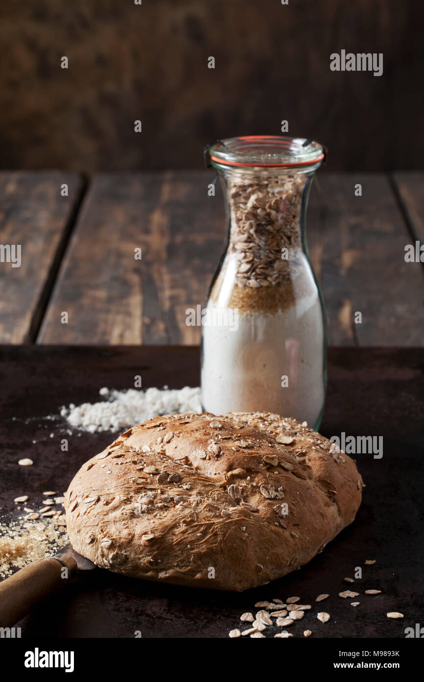 Spelt bread and glass bottle of ingredients for spelt bread Stock Photo
