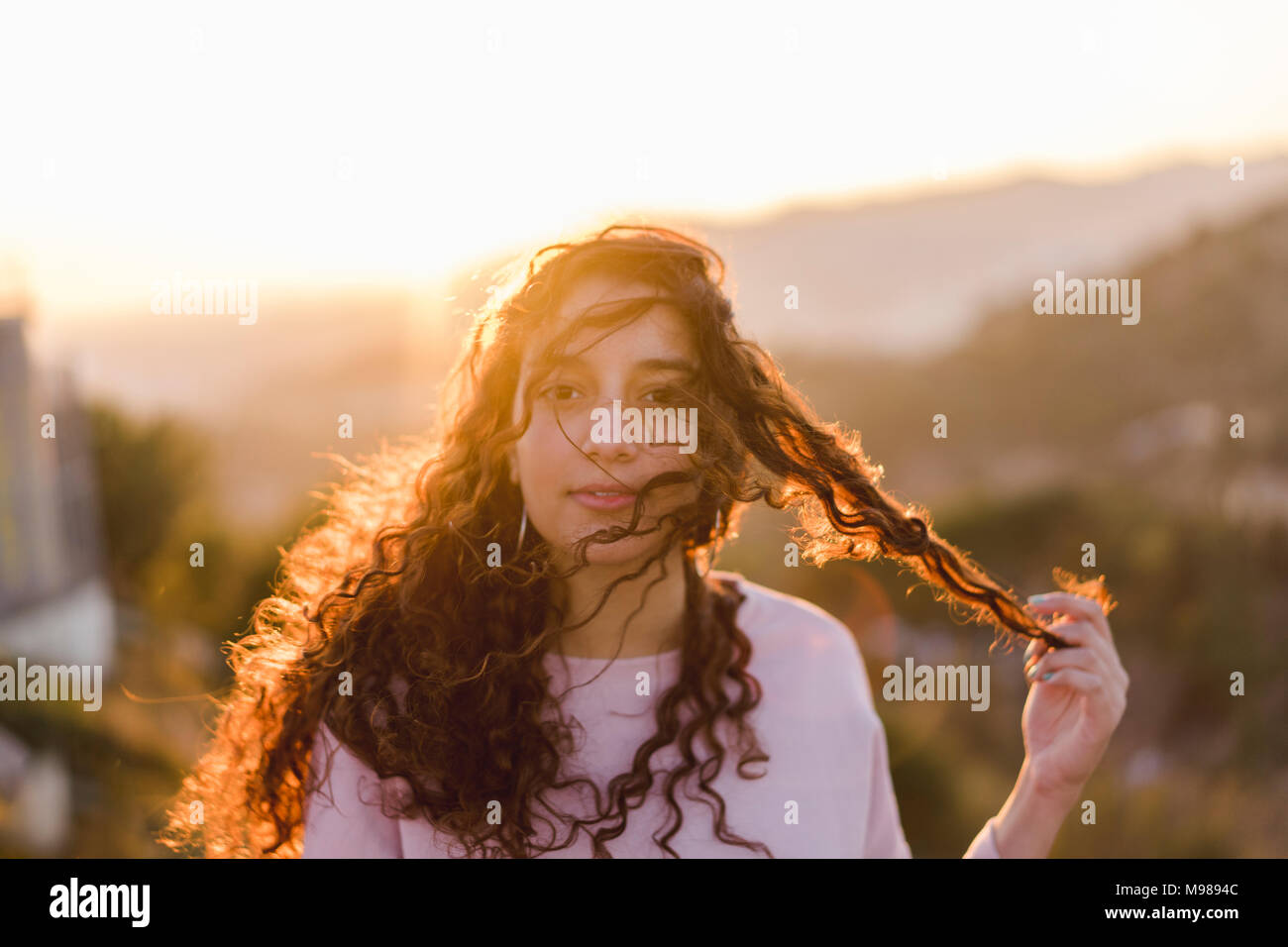 Woman with long curly hair hi-res stock photography and images - Alamy