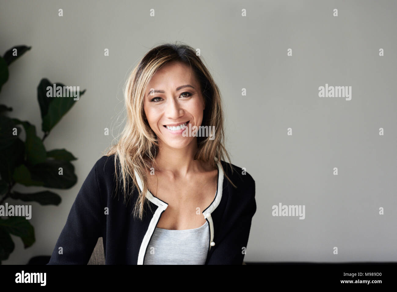 Portrait of a happy beautiful middle aged asian woman at home. Stock Photo