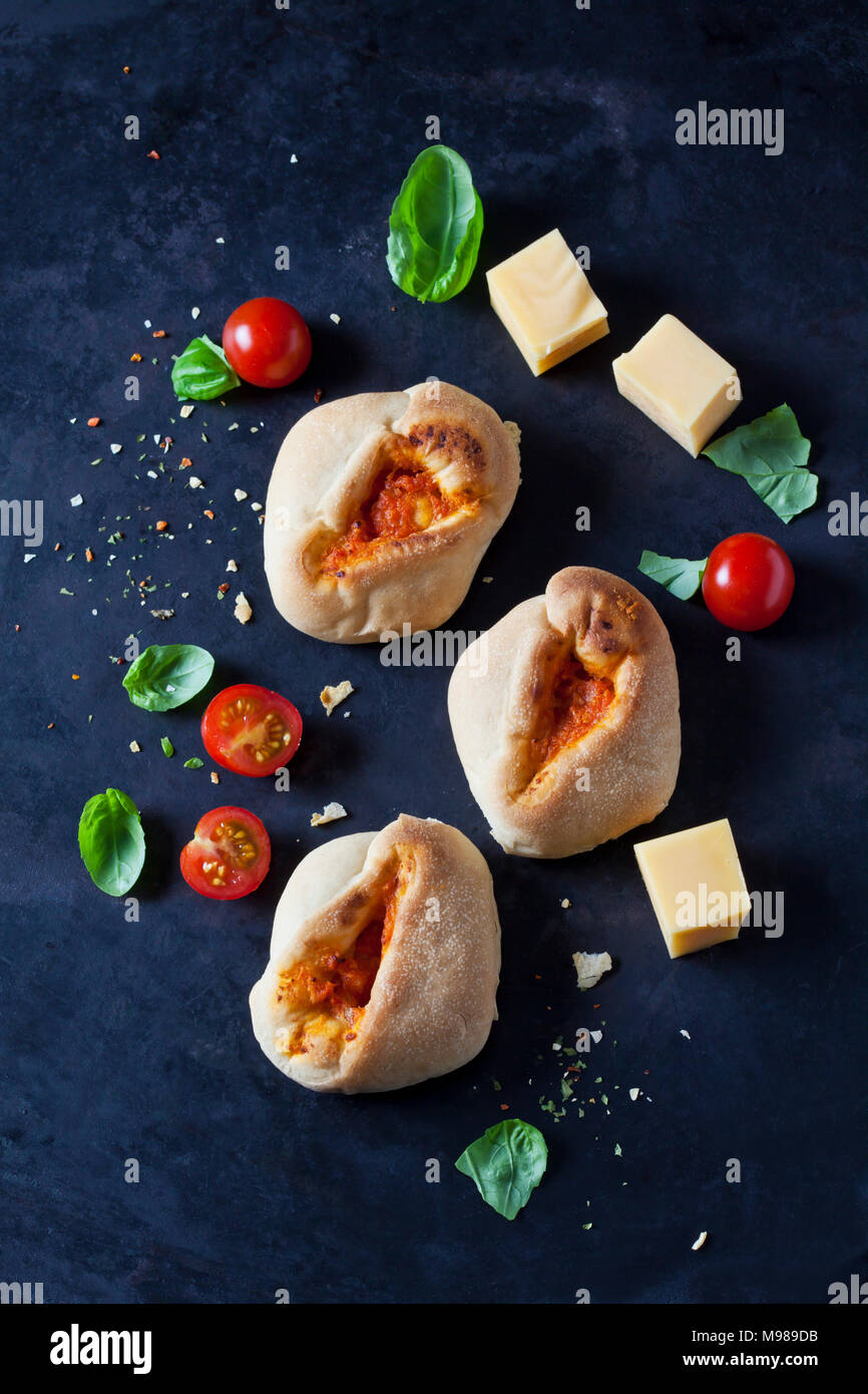 Pizza sticky buns, cherry tomatoes, diced cheese and basil leaves Stock Photo