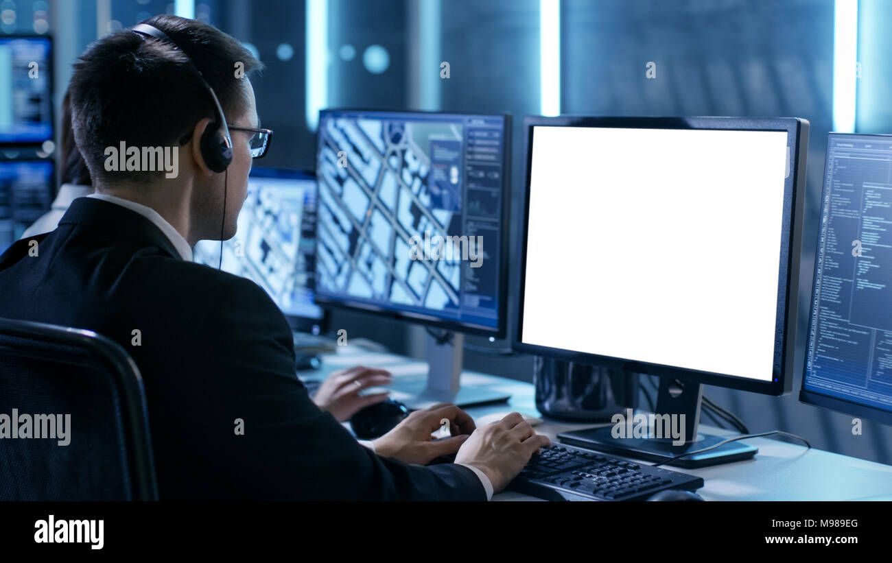 Professional IT Engineers Working in System Control Center Full of Monitors and Servers. Possibly Government Agency Conducts Investigation. Stock Photo