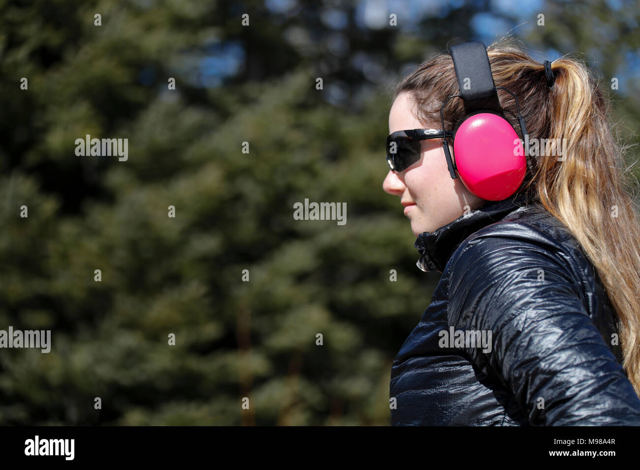 Young woman wearing eye and ear protection. Stock Photo