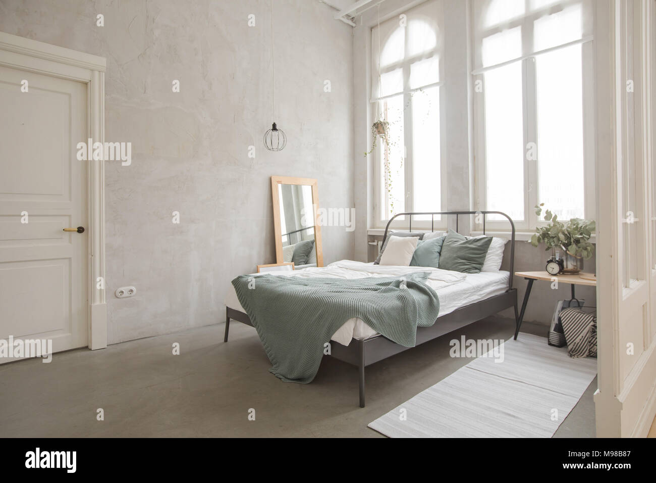 Interior of white and gray cozy bedroom Stock Photo - Alamy