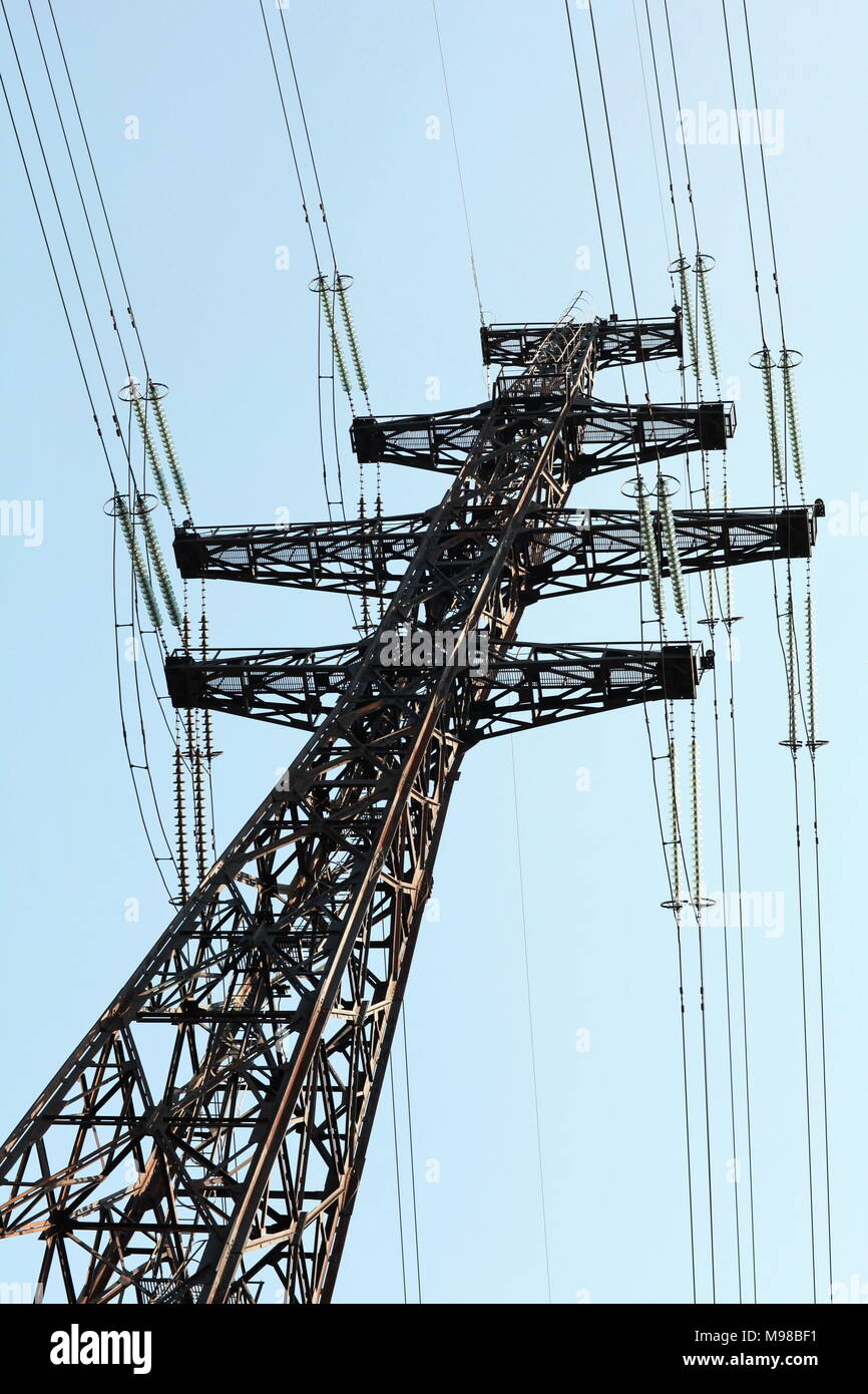 Power lines and electricity pylon against blue sky Stock Photo - Alamy