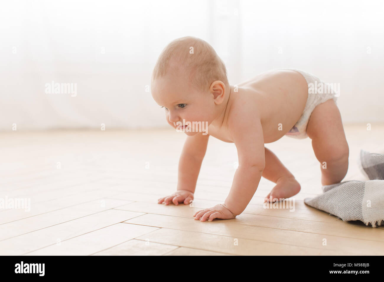 Baby crawling on all fours Stock Photo