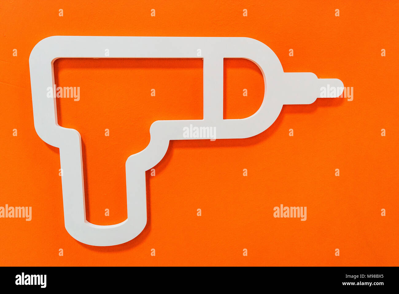 Drill icon on wall in house appliances store Stock Photo