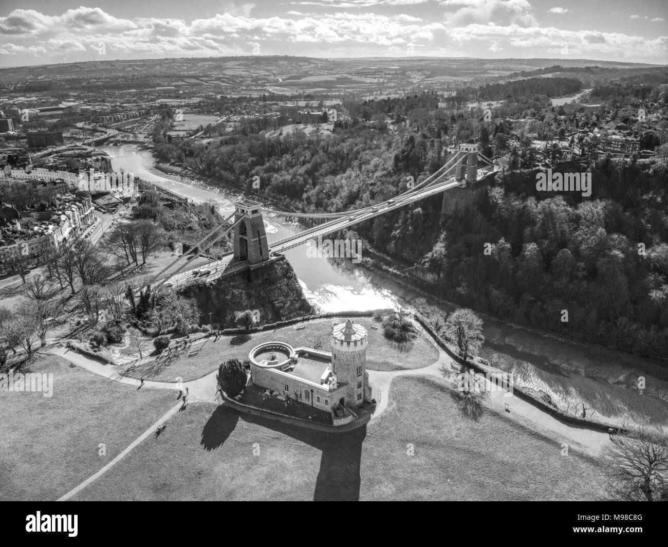 Aerial shot of Clifton Suspension Bridge spanning the Avon Gorge and Clifton Observatory, Bristol, UK - Black and white Stock Photo