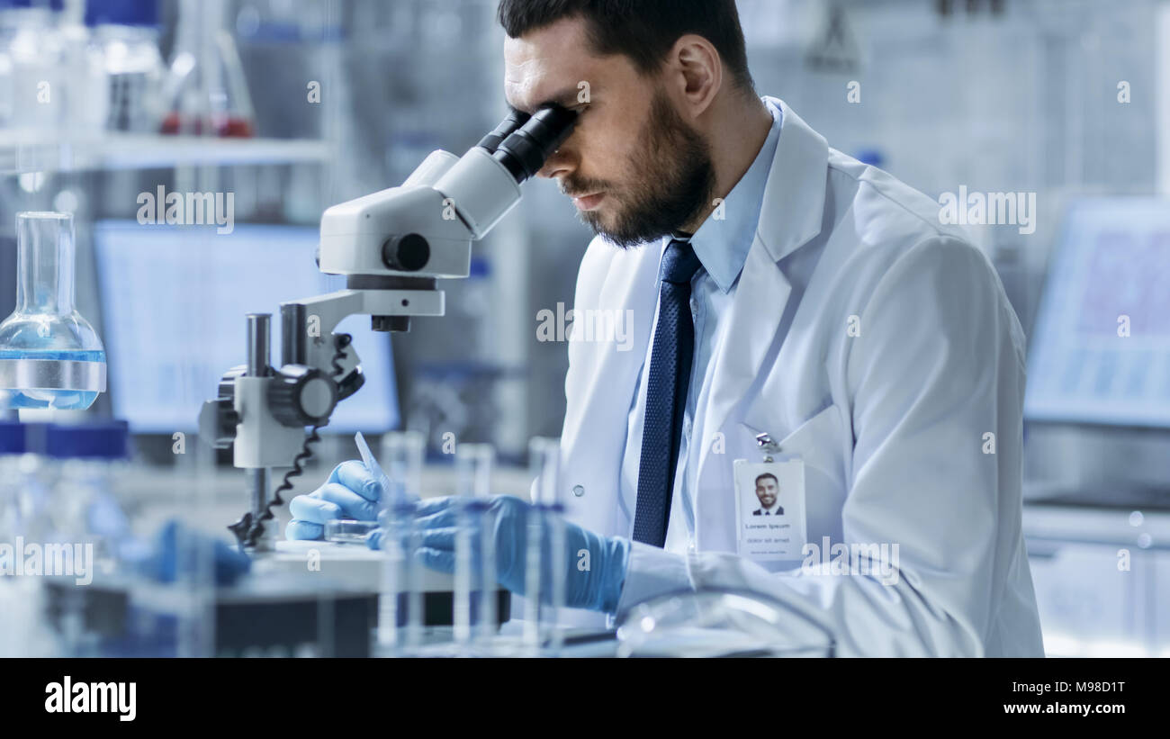 Research Scientist Adjusts Specimen in a Petri Dish and Looks on it