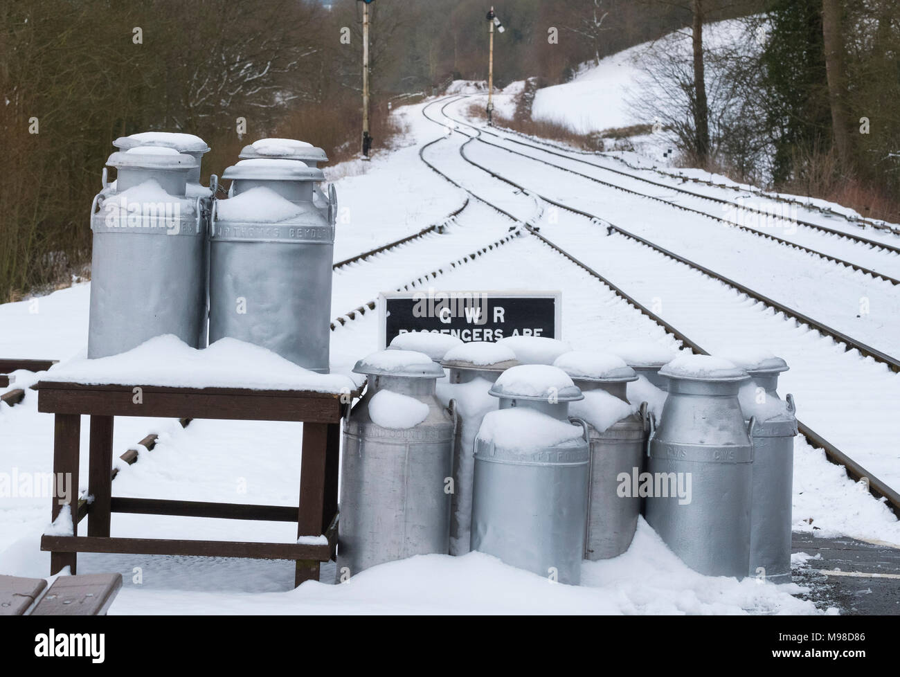 Snow covered milk churns on platform at Hampton Loade station, Severn Valley Railway near Bridgnorth, Shropshire, UK Stock Photo