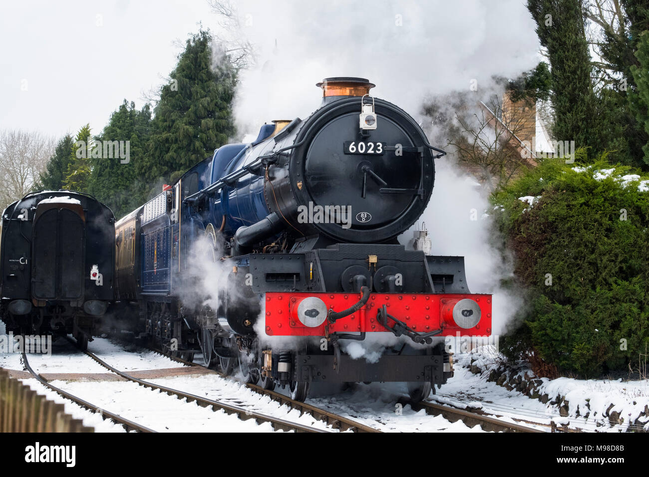 King Edward II steam locomotive pulling out of Hampton Loade station in snow on the Severn Valley Railway, Shropshire. Stock Photo