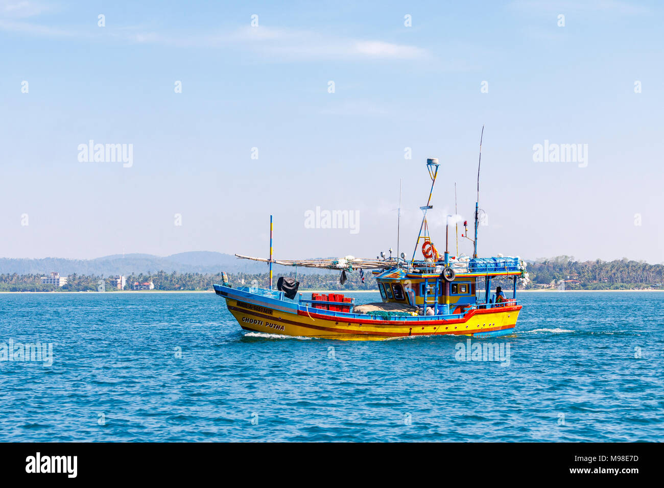 Colourful typical wooden small fishing boat at sea sailing in Weligama Bay, Mirissa, on the south coast of Sri Lanka Stock Photo