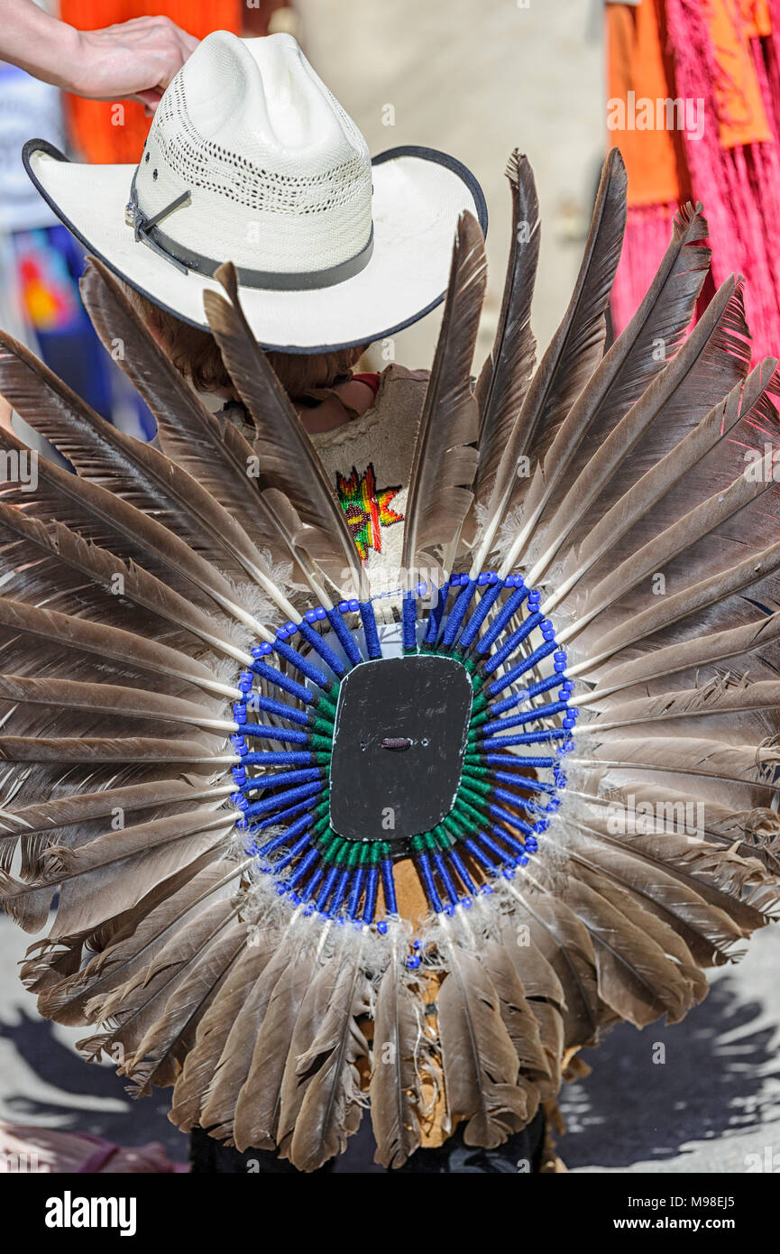 Native male wearing a cowboy hat and an eagle feather  bustle (regalia) at the Calgary Stampede in Canada Stock Photo