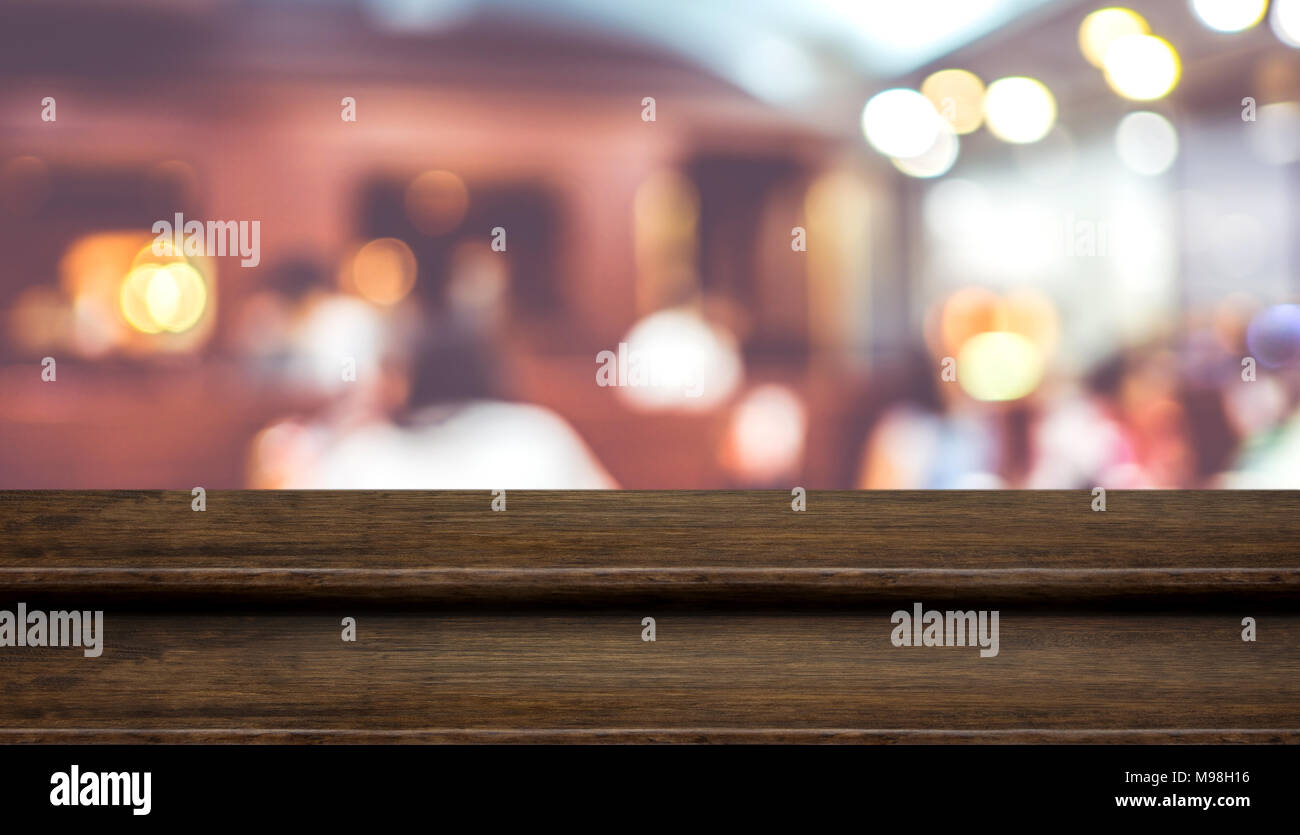 Empty step dark wood table top food stand with blur cafe restaurant background bokeh light,Mock up for product display or montage of design,Banner for Stock Photo