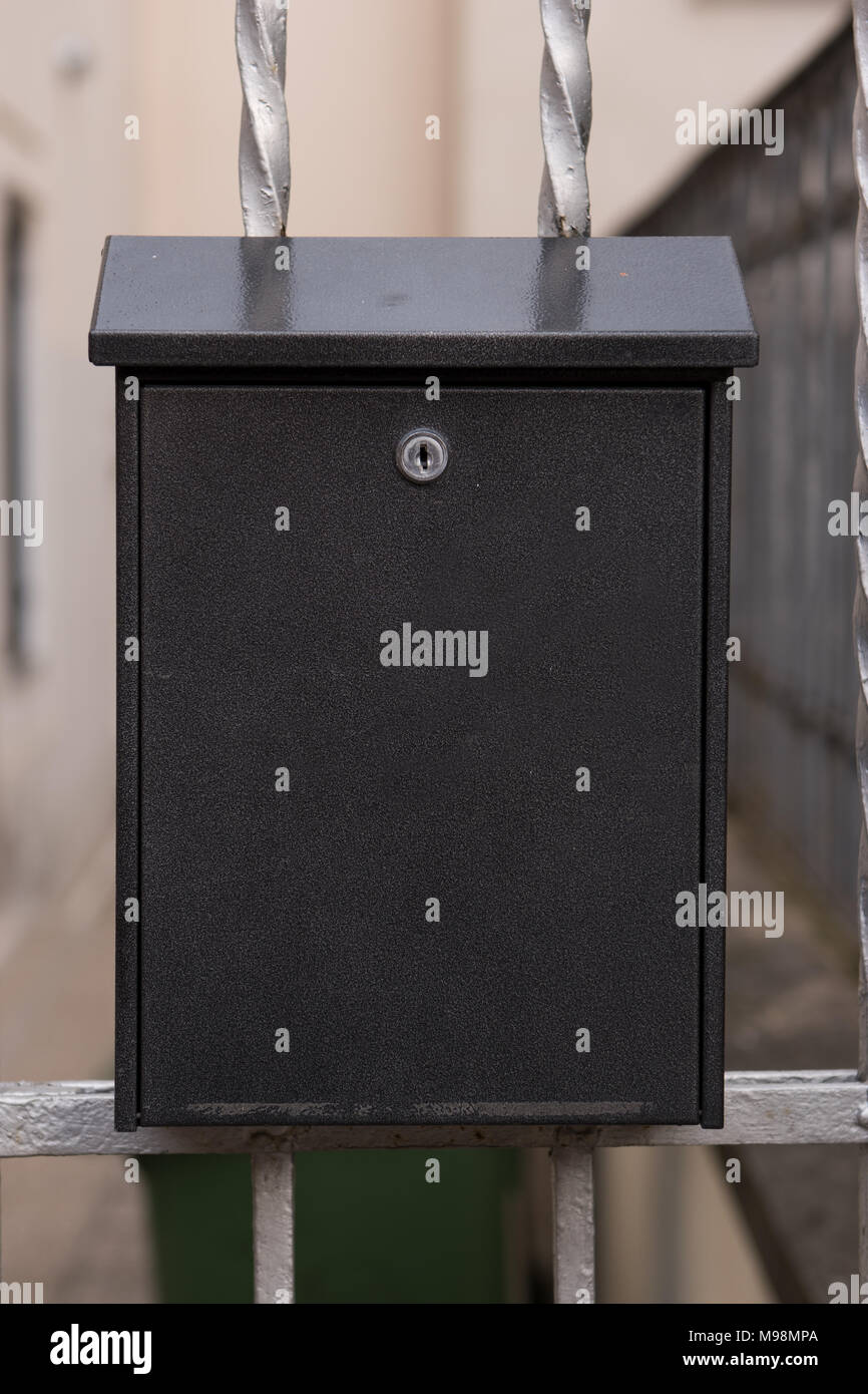 Black modern metal mailbox on outside doors Stock Photo Alamy