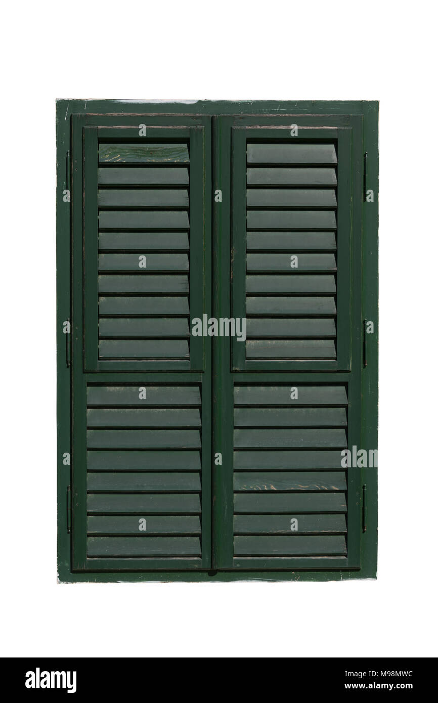 Closed old window with green wooden shutters isolated on white background. Stock Photo