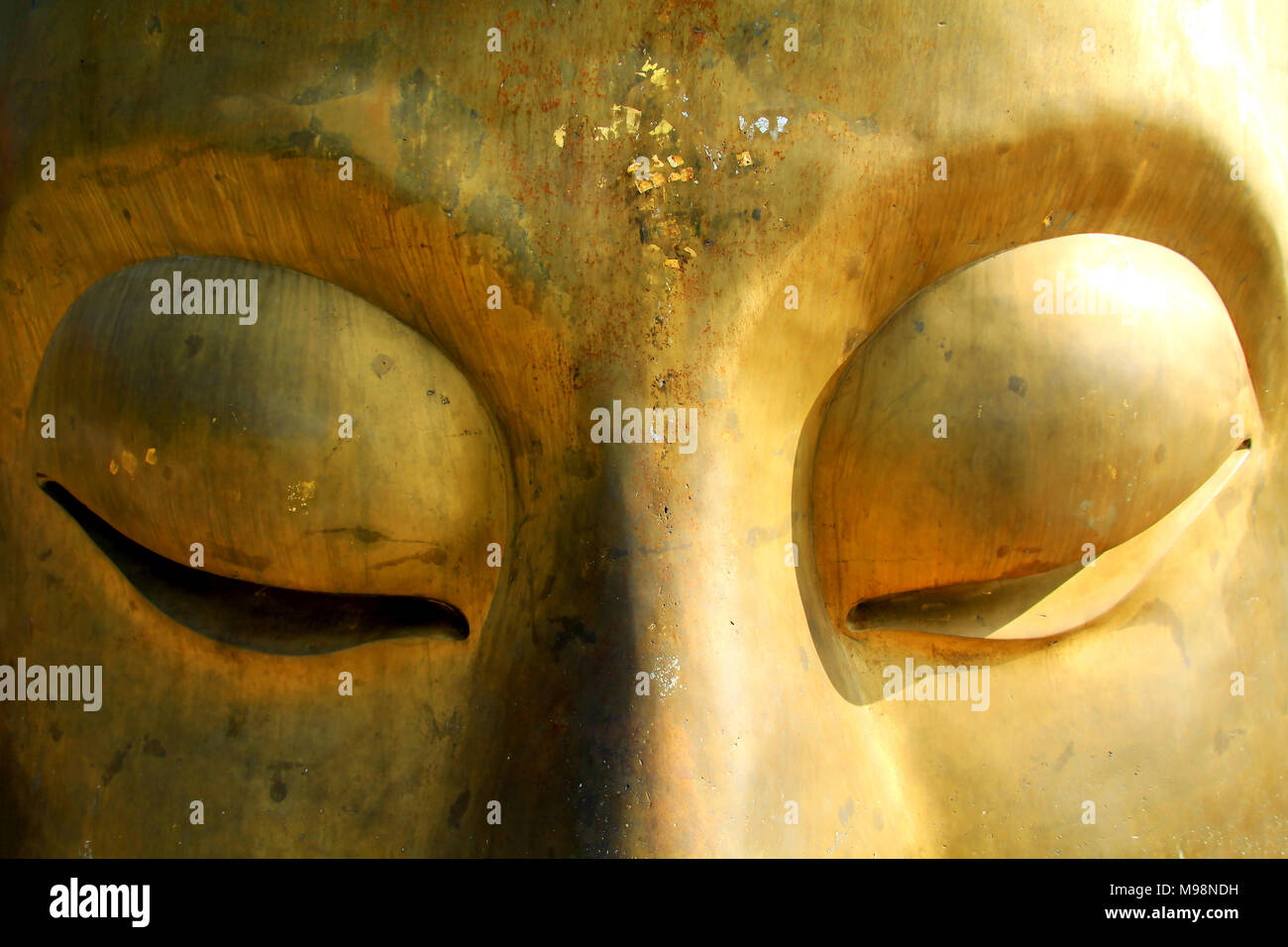 Close-up of buddha face with light and shade. Stock Photo
