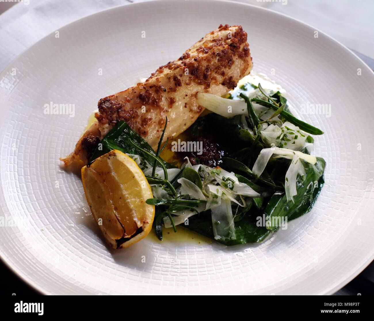 Halibut with wild garlic and Vadouvan spice blend at Scully Restaurant, St James's, London Stock Photo