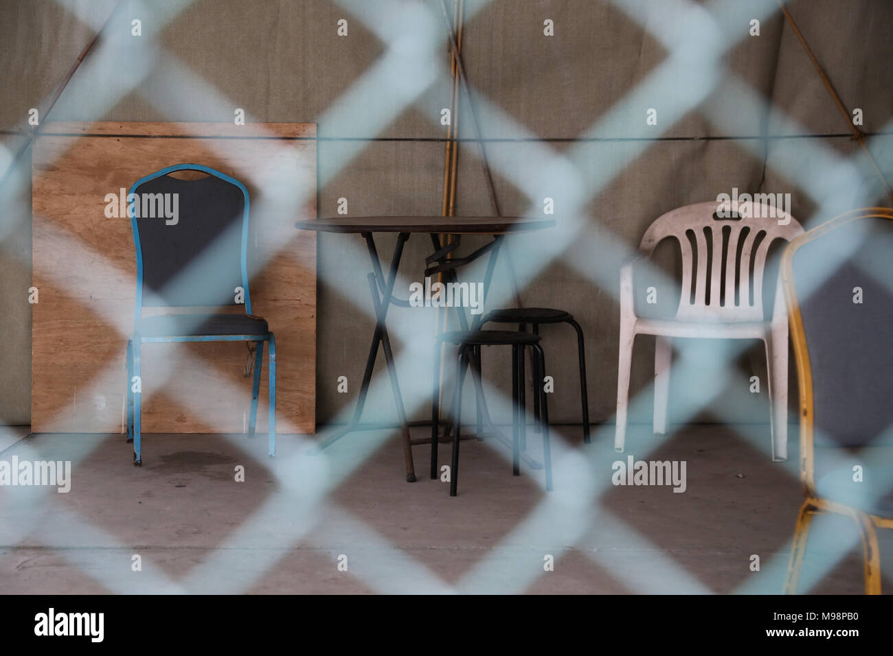 Chair and table beyond barbed wire in HongKong Stock Photo