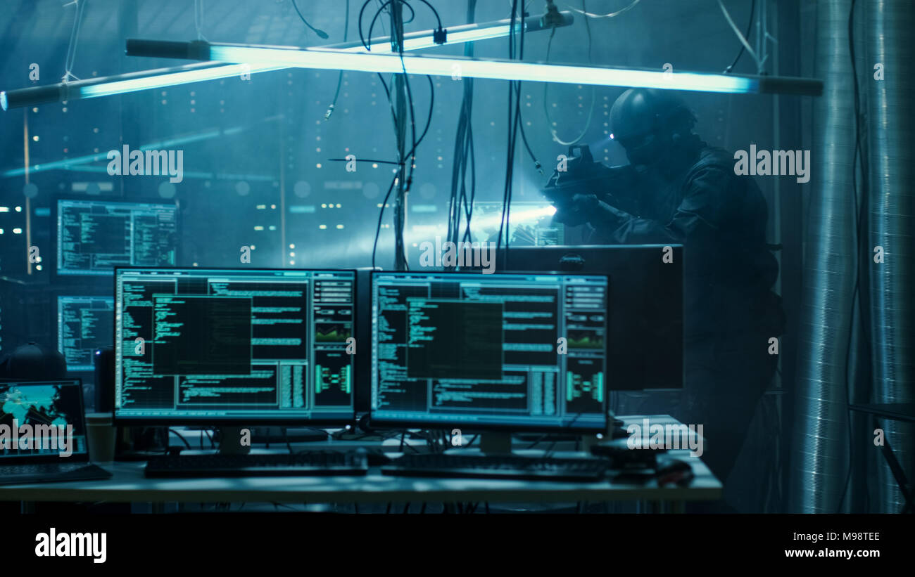 Cyber War Special Forces Fully Armed Soldier Uncovers Internationally Wanted Hacker's Hideout Place. Lair is Full of Monitors, Cables and Has Neon. Stock Photo