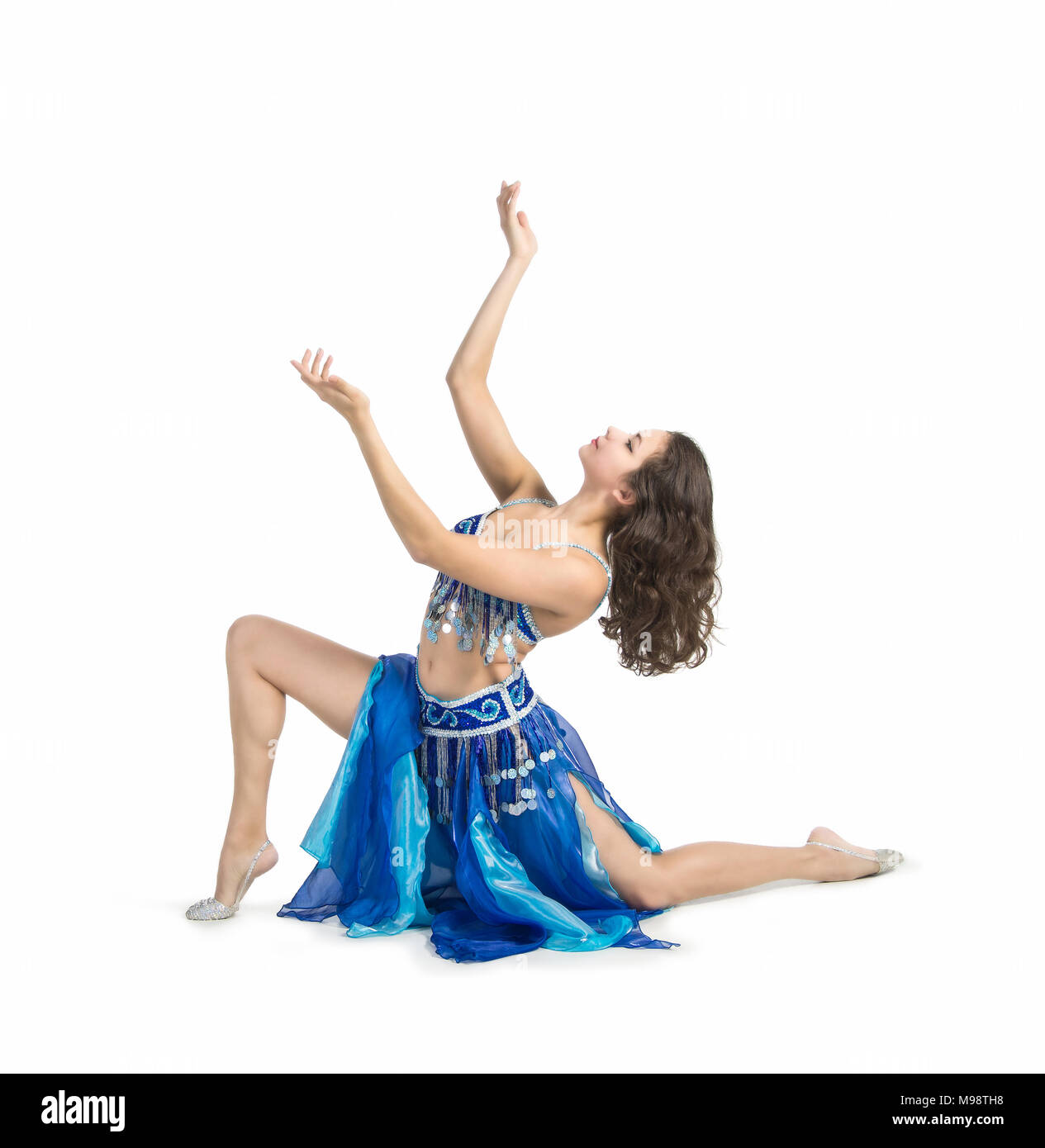 Smiling woman dancing the Eastern dance.The performance on the stage belly dancing. Shooting in Studio on white background isolated image. Stock Photo